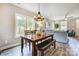 Bright dining area with wooden table and bench, looking into living room at 226 Hickory St, Locust, NC 28097