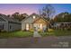 House exterior at dusk with landscaping and American flag at 226 Hickory St, Locust, NC 28097