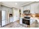 Modern kitchen with stainless steel appliances and granite countertops at 226 Hickory St, Locust, NC 28097