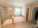 Bathroom features a shower, garden tub, and toilet at 3960 Farmington Ridge Pkwy, Charlotte, NC 28213