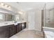 Elegant bathroom with double vanity and large shower at 3960 Farmington Ridge Pkwy, Charlotte, NC 28213