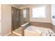 Bathroom with a walk-in shower and a soaking tub at 3960 Farmington Ridge Pkwy, Charlotte, NC 28213