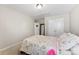 Bright bedroom with double doors and a floral comforter at 3960 Farmington Ridge Pkwy, Charlotte, NC 28213