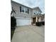 Two-story house with a beige exterior, white garage door, and basketball hoop at 3960 Farmington Ridge Pkwy, Charlotte, NC 28213