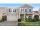 Two-story house with stone accents, a two-car garage, and a basketball hoop at 3960 Farmington Ridge Pkwy, Charlotte, NC 28213