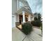 Inviting front porch with stone pillars and comfortable wicker chairs at 3960 Farmington Ridge Pkwy, Charlotte, NC 28213