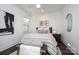 Well-lit bedroom with ceiling fan, art, and a comfy-looking bed at 411 Newstyle Way # 4, Cramerton, NC 28056