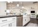 Modern kitchen featuring a large island with bar seating, white cabinets, and a farmhouse sink at 411 Newstyle Way # 4, Cramerton, NC 28056