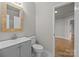 Modern bathroom with gray vanity, white toilet and a wood framed mirror at 4759 Mel Nunnery Rd, Fort Lawn, SC 29714