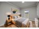 Bedroom with a wood-framed bed, neutral bedding, and natural light from the window at 4759 Mel Nunnery Rd, Fort Lawn, SC 29714