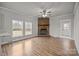 Inviting living area showcases wood floors, a brick fireplace, neutral walls, and natural lighting at 4759 Mel Nunnery Rd, Fort Lawn, SC 29714