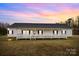 Ranch style home with gray roof and a long front porch at 4759 Mel Nunnery Rd, Fort Lawn, SC 29714