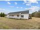 Ranch-style house with a wide porch and neutral siding, sitting on a well-manicured lawn under a blue sky at 4759 Mel Nunnery Rd, Fort Lawn, SC 29714