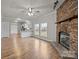 Open living room and kitchen with hardwood floors and a stone fireplace at 4759 Mel Nunnery Rd, Fort Lawn, SC 29714