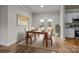 Dining area with a table set for six, bathed in natural light from adjacent patio doors at 4759 Mel Nunnery Rd, Fort Lawn, SC 29714