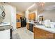 Cozy kitchen with oak cabinets, black appliances, and a practical layout at 5218 Haybridge Rd, Charlotte, NC 28269