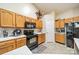 Bright kitchen with oak cabinets, and black appliances at 5218 Haybridge Rd, Charlotte, NC 28269