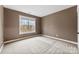 Simple bedroom with large window and neutral walls at 7708 Spanish Oaks Dr, Waxhaw, NC 28173