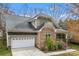 Charming home featuring stone accents, a covered porch, and a two-car garage at 7708 Spanish Oaks Dr, Waxhaw, NC 28173