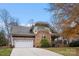 Charming home featuring stone accents, a covered porch, and a two-car garage at 7708 Spanish Oaks Dr, Waxhaw, NC 28173