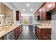 Modern kitchen with granite countertops and tile flooring at 7708 Spanish Oaks Dr, Waxhaw, NC 28173