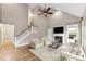 Bright living room featuring vaulted ceilings, a fireplace, and hardwood floors at 7708 Spanish Oaks Dr, Waxhaw, NC 28173