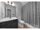 Clean bathroom with dark vanity, white sink, and checkered shower curtain at 7721 Sedgebrook E Dr, Stanley, NC 28164