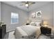 Virtually staged bedroom with neutral decor and ceiling fan at 7721 Sedgebrook E Dr, Stanley, NC 28164