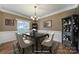 Virtually staged dining room with elegant table and cabinetry at 7721 Sedgebrook E Dr, Stanley, NC 28164