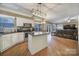 Open kitchen features an island and flows into the living room at 7721 Sedgebrook E Dr, Stanley, NC 28164