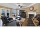 Living room with fireplace, hardwood floors, and leather furniture at 7721 Sedgebrook E Dr, Stanley, NC 28164