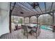 Pergola deck with table and chairs overlooking pool and woods at 7721 Sedgebrook E Dr, Stanley, NC 28164