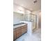 Bathroom with double sink vanity, marble tile flooring and glass shower enclosure at 7932 Cedarsmith Ct, Charlotte, NC 28217