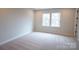 Unfurnished bedroom featuring neutral carpet, trim and paint and a double window at 7932 Cedarsmith Ct, Charlotte, NC 28217