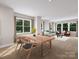 Dining room with wood table set and view into the living area at 7932 Cedarsmith Ct, Charlotte, NC 28217