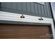 Close up of modern townhouse exterior featuring a brown garage door and black outdoor lighting at 7932 Cedarsmith Ct, Charlotte, NC 28217