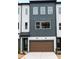 Stylish townhome features a modern design with a two-car garage and manicured landscaping at 7932 Cedarsmith Ct, Charlotte, NC 28217