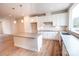 Modern kitchen with a center island, white cabinetry, and stainless steel appliances at 7932 Cedarsmith Ct, Charlotte, NC 28217