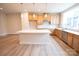 Kitchen featuring wood cabinets, stainless steel appliances, island and large window at 7932 Cedarsmith Ct, Charlotte, NC 28217