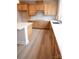 Well-lit kitchen with wood cabinets, white countertop, stainless steel sink and faucet at 7932 Cedarsmith Ct, Charlotte, NC 28217