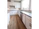 Well-lit kitchen with white cabinets, subway tile backsplash, and modern fixtures at 7932 Cedarsmith Ct, Charlotte, NC 28217