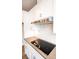 Close up of kitchen featuring stainless steel range hood over an electric cooktop and subway tile backsplash at 7932 Cedarsmith Ct, Charlotte, NC 28217