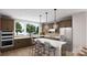 Modern kitchen with island, stainless steel appliances, and view to backyard at 7932 Cedarsmith Ct, Charlotte, NC 28217