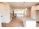 Spacious living room features a kitchen island, hardwood floors and neutral paint at 7932 Cedarsmith Ct, Charlotte, NC 28217