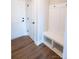 Mudroom features coat hooks, a built-in bench, and wood-look vinyl floors at 7932 Cedarsmith Ct, Charlotte, NC 28217