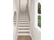 Elegant staircase with light wood and white risers at 7932 Cedarsmith Ct, Charlotte, NC 28217