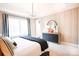 Serene bedroom featuring a round mirror and a dresser at 8008 Cedarsmith Ct, Charlotte, NC 28217