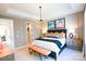 Bright bedroom with a modern chandelier and ensuite access at 8008 Cedarsmith Ct, Charlotte, NC 28217