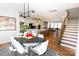 Open concept dining room with modern table and kitchen view at 8008 Cedarsmith Ct, Charlotte, NC 28217