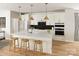 Modern kitchen with white cabinets, quartz countertops, and stainless steel appliances at 8008 Cedarsmith Ct, Charlotte, NC 28217